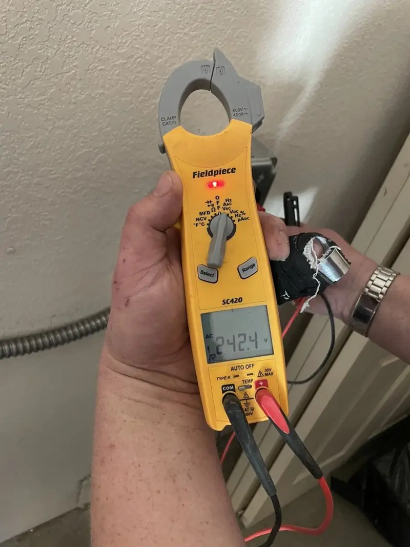 Voltage testing with clamp meter during Whole House Surge Protector in Moss Bluff